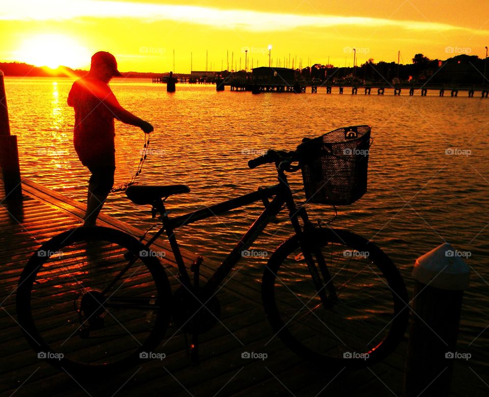 Boy and bike. A boy stop  riding hit bike to admire the golden hour