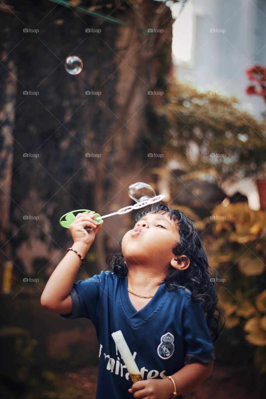 girl with bubble maker