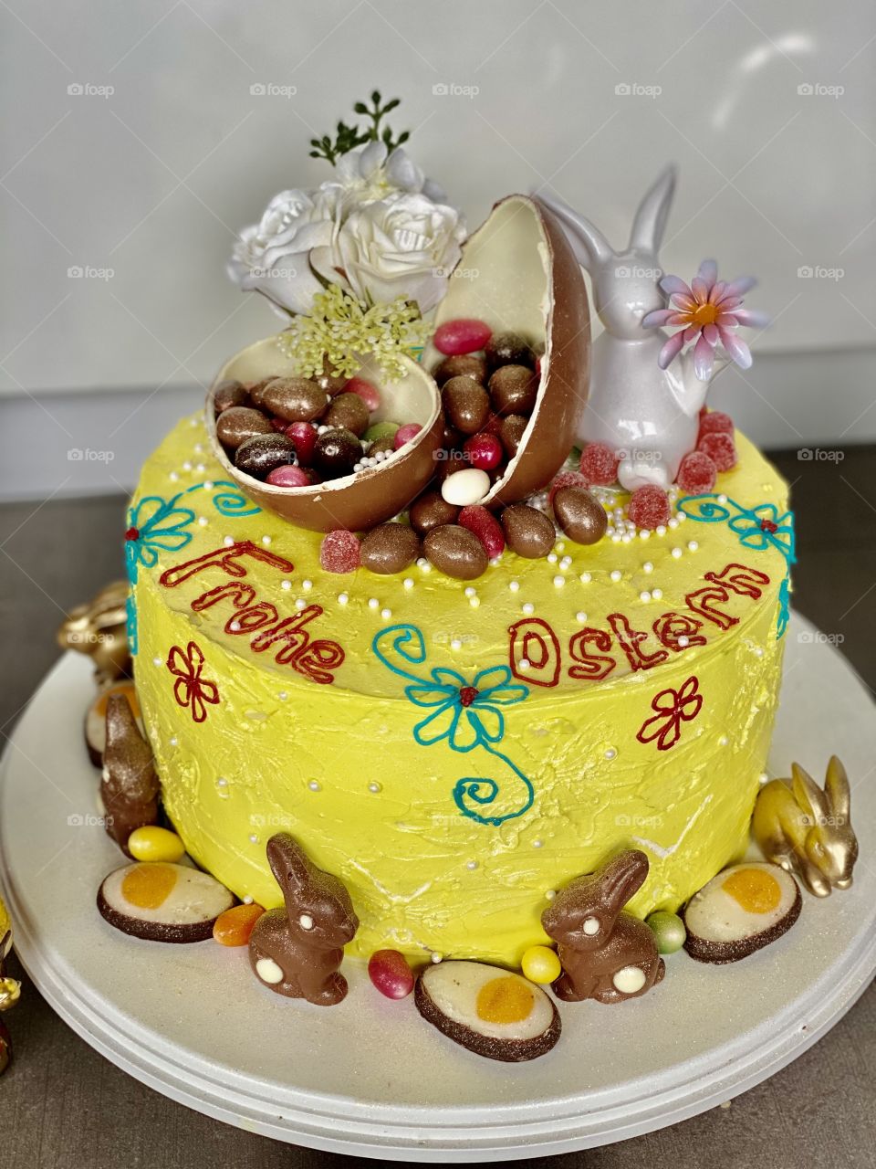 yellow Easter cake, birthday cake, bunny cake, chocolate bunnies, chocolate eggs, colored eggs, Easter eggs, colorful eggs, flowers on the cake, good Easter, raspberry cream cake