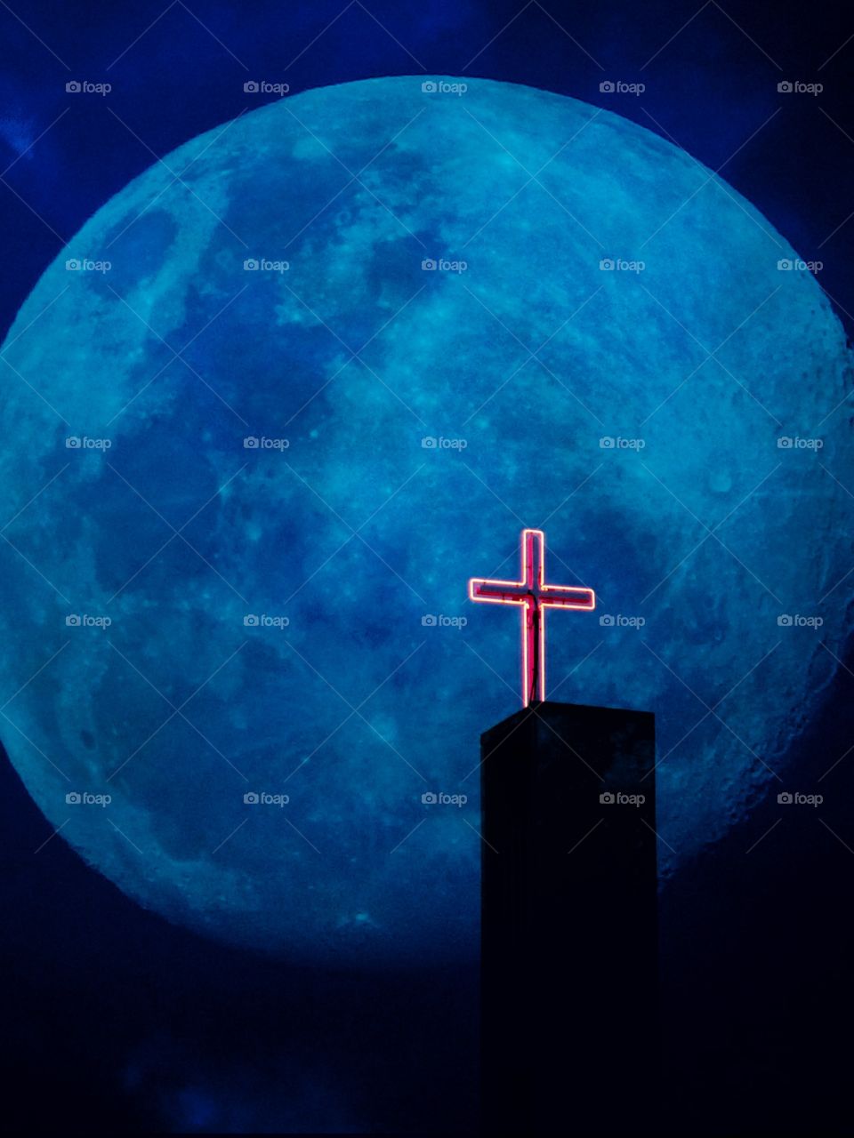 Red crucifix against a big blue moon 
