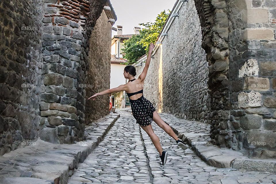 A girl jumps on the street