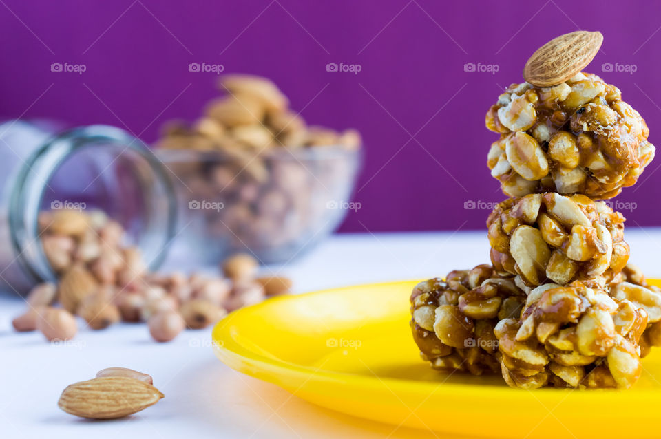 Healthy and nutritional peanut badam chikki balls coated with jaggery.