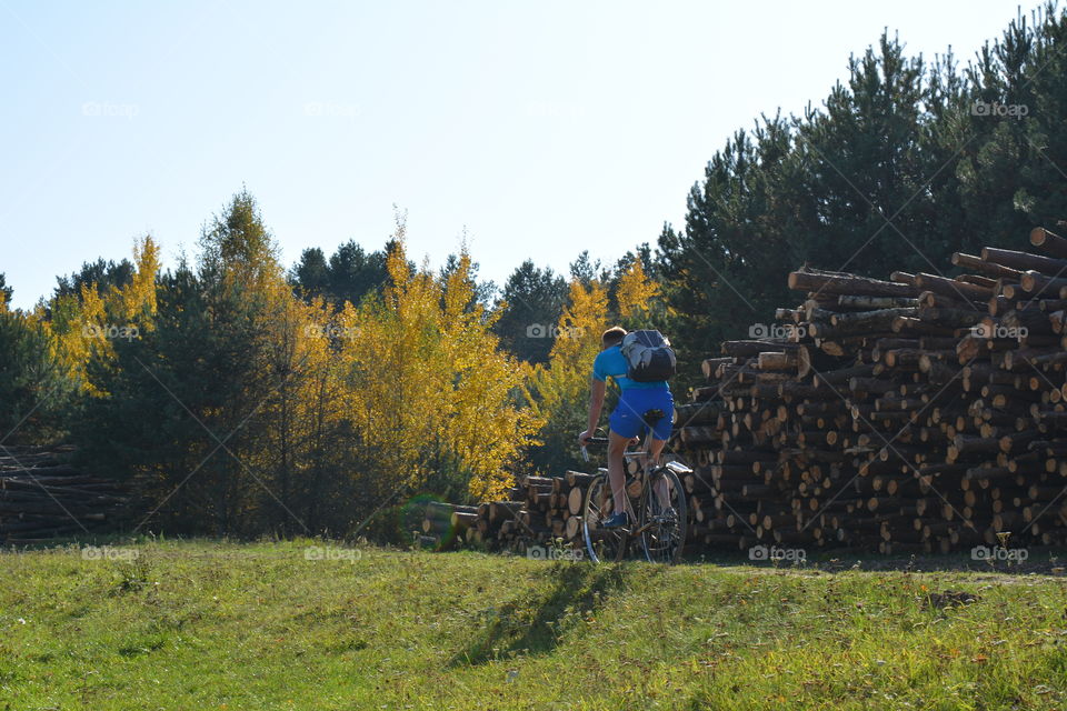 person riding on a bike autumn landscape, social distance