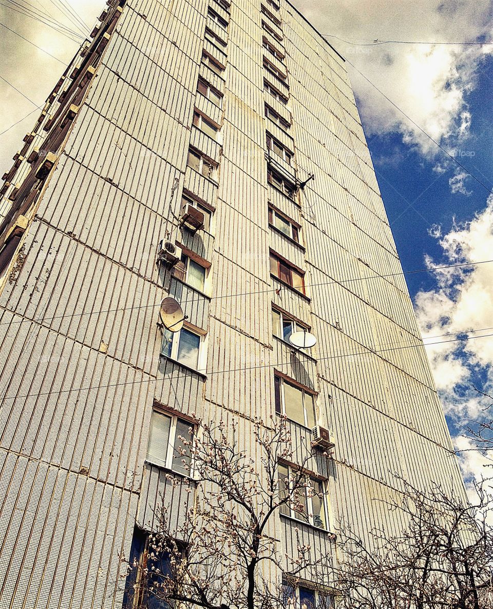 multi-storey apartment building under the clouds.