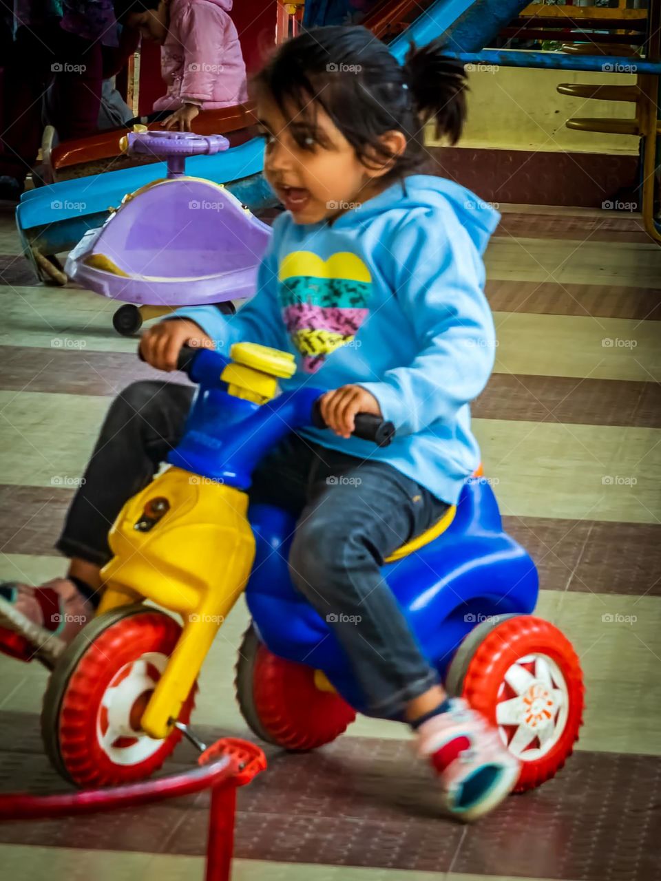 cute little girl playing on her scooter