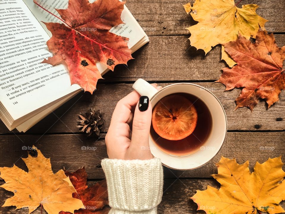 Autumn flat lay with book, cup of tea and leaves