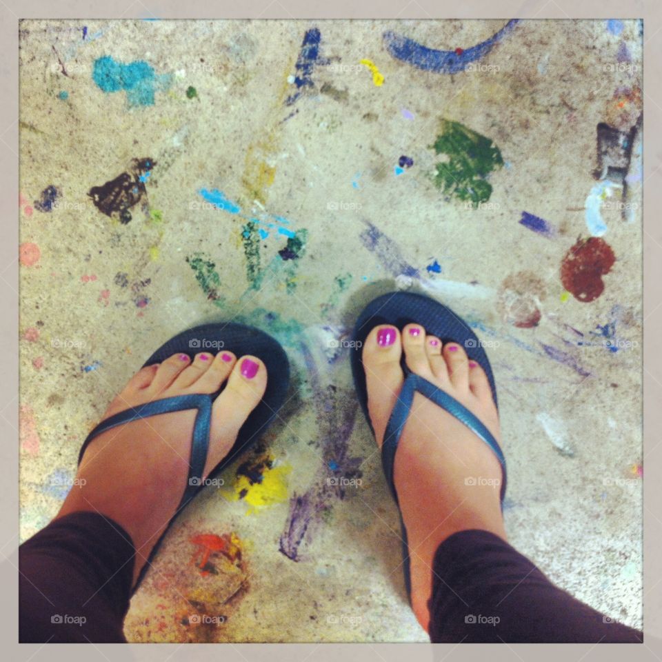 Art studio floor feet in flip flops