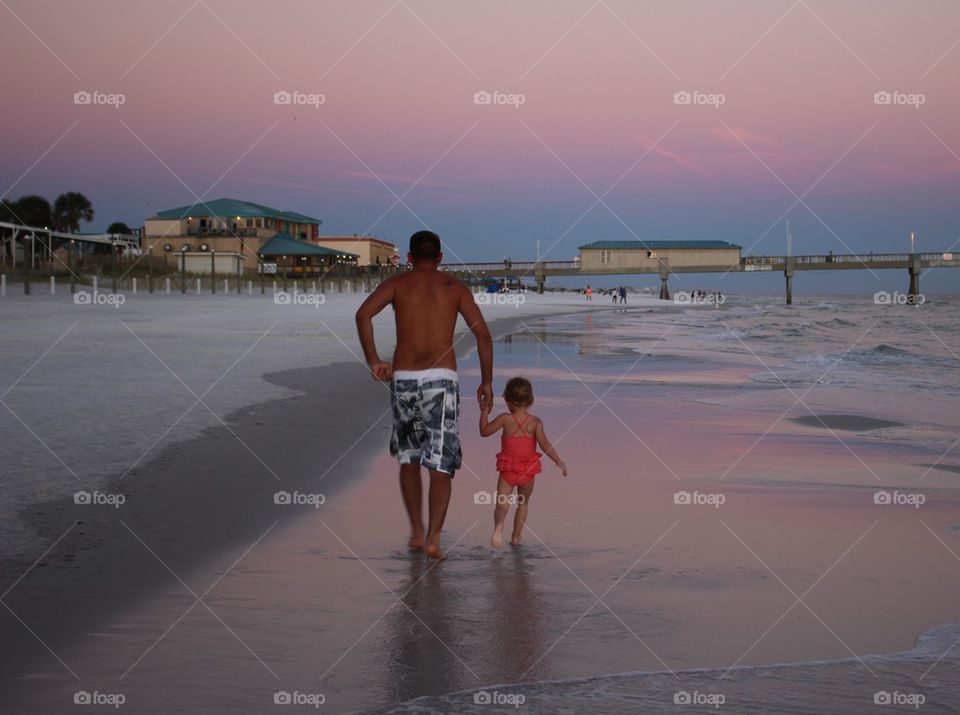 Father daughter running on the beach