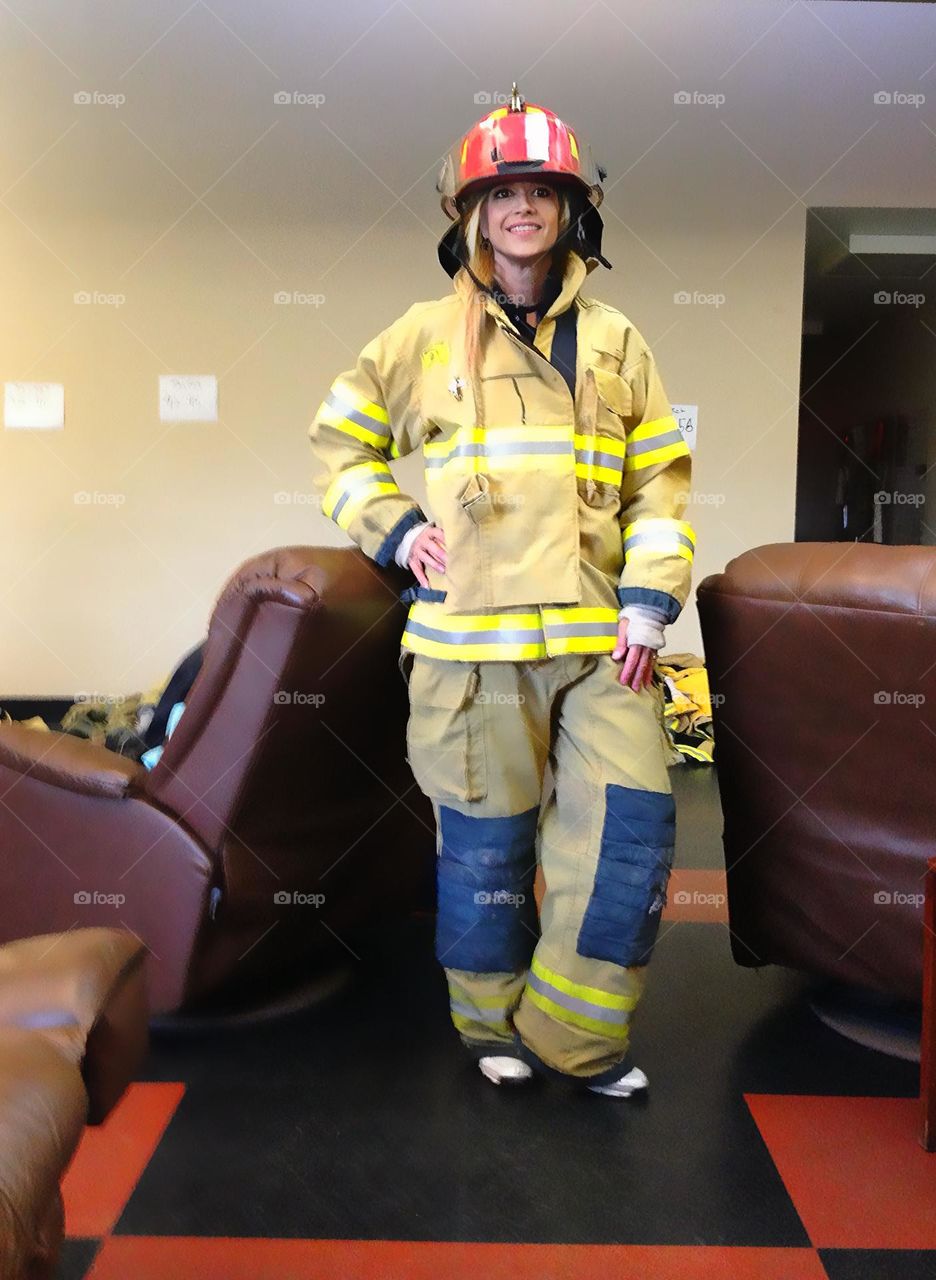 Woman firefighter in uniform at the firestation.