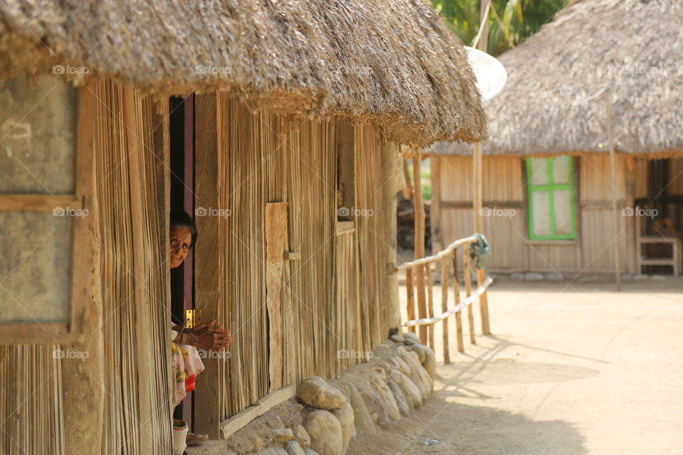 a Timorese woman in a traditional hut