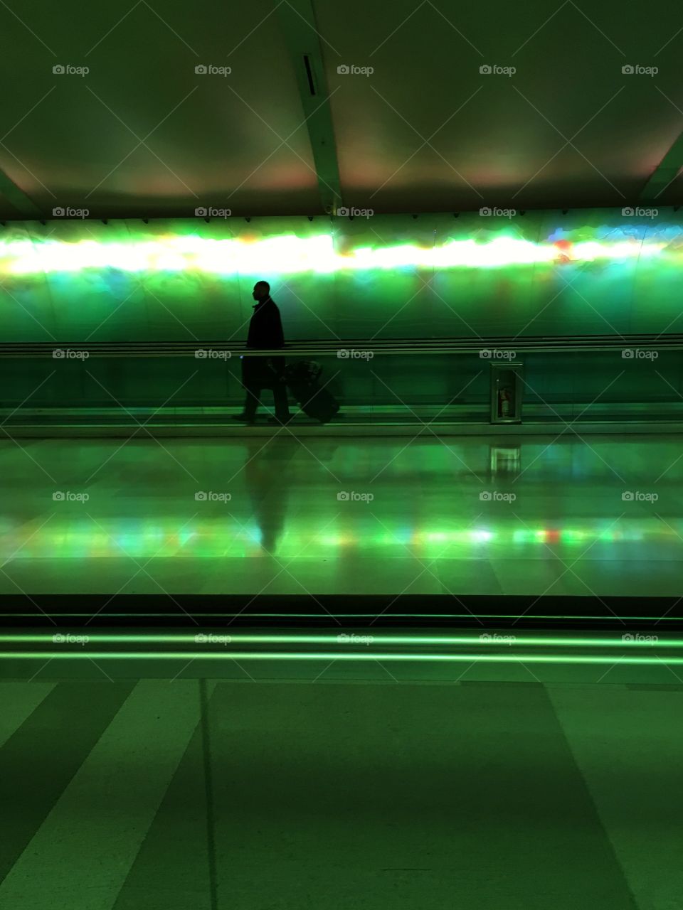 Detroit airport has the coolest lights, creating an awesome silhouette of travelers 
