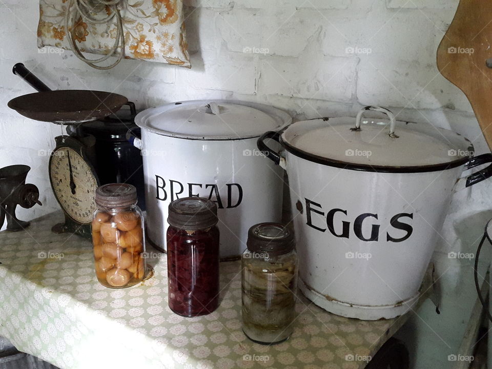 Country cooking at its best. A touch of vintage kitchen goodies. some basic ingredients and homemade jars of pickles ready to set the table with