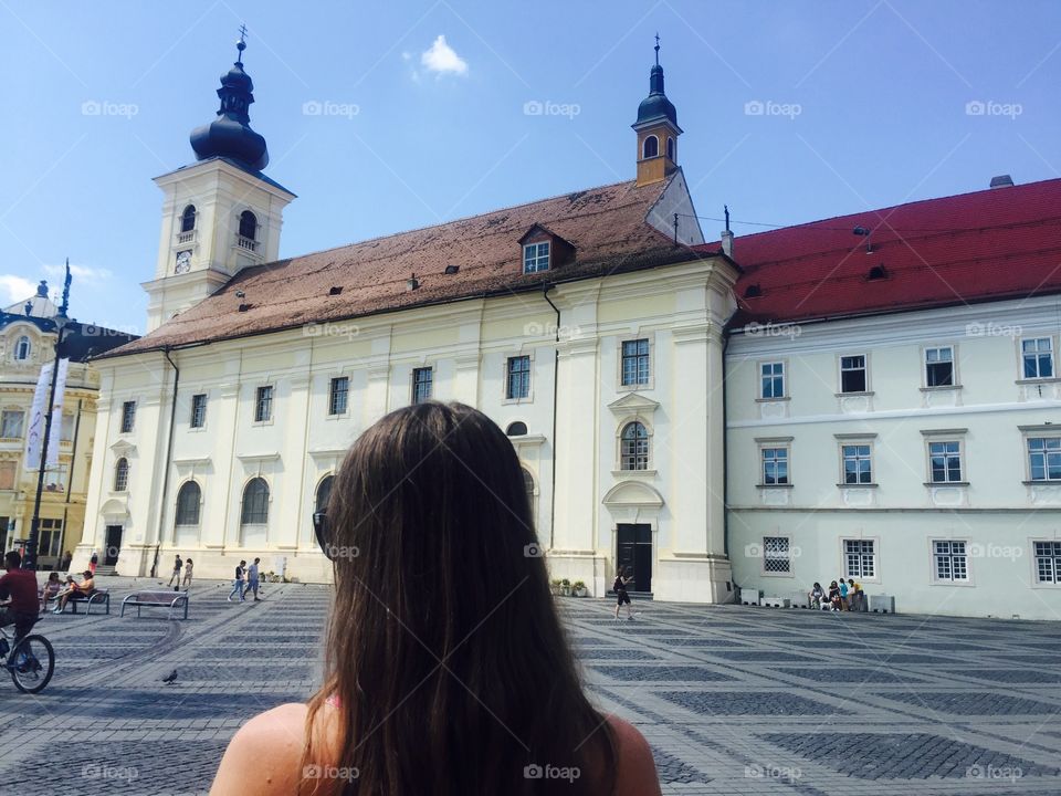 back of woman looking at buildings