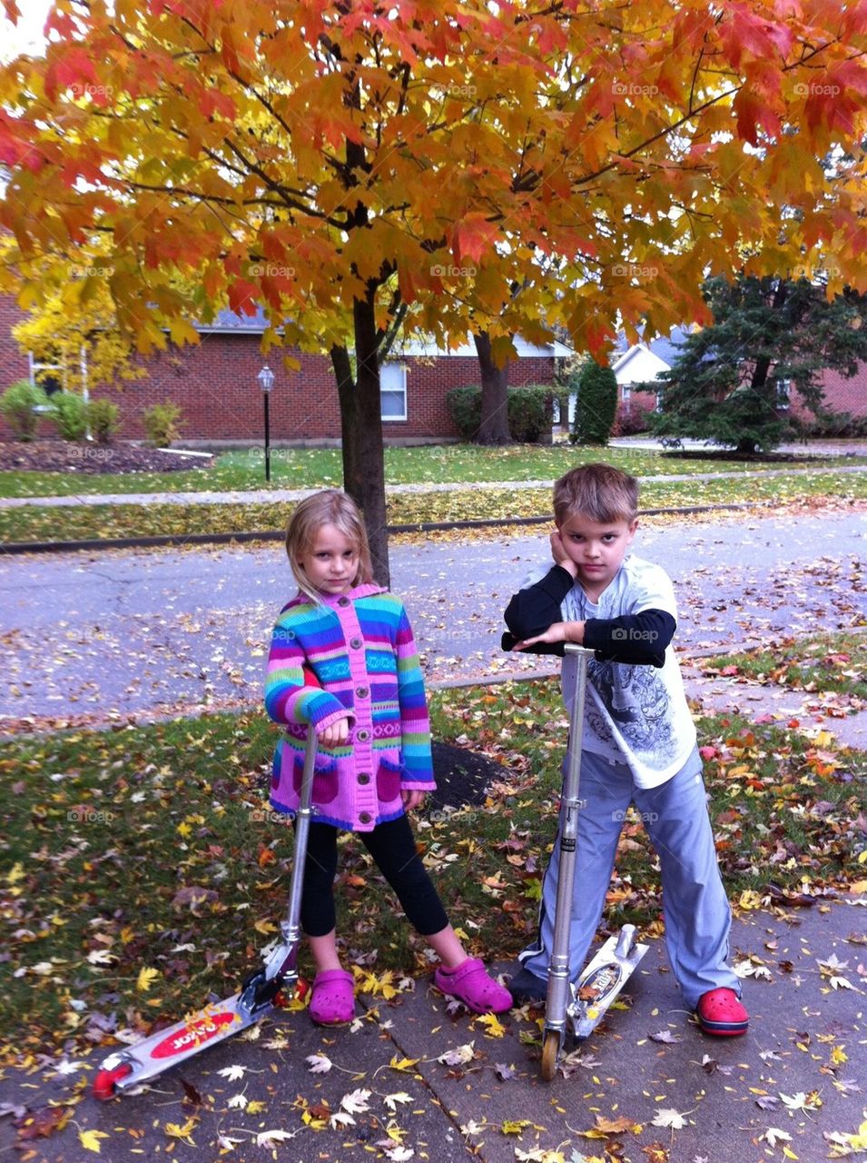 Kids posing on scooters