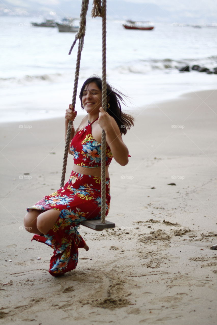 a happy woman on a swing