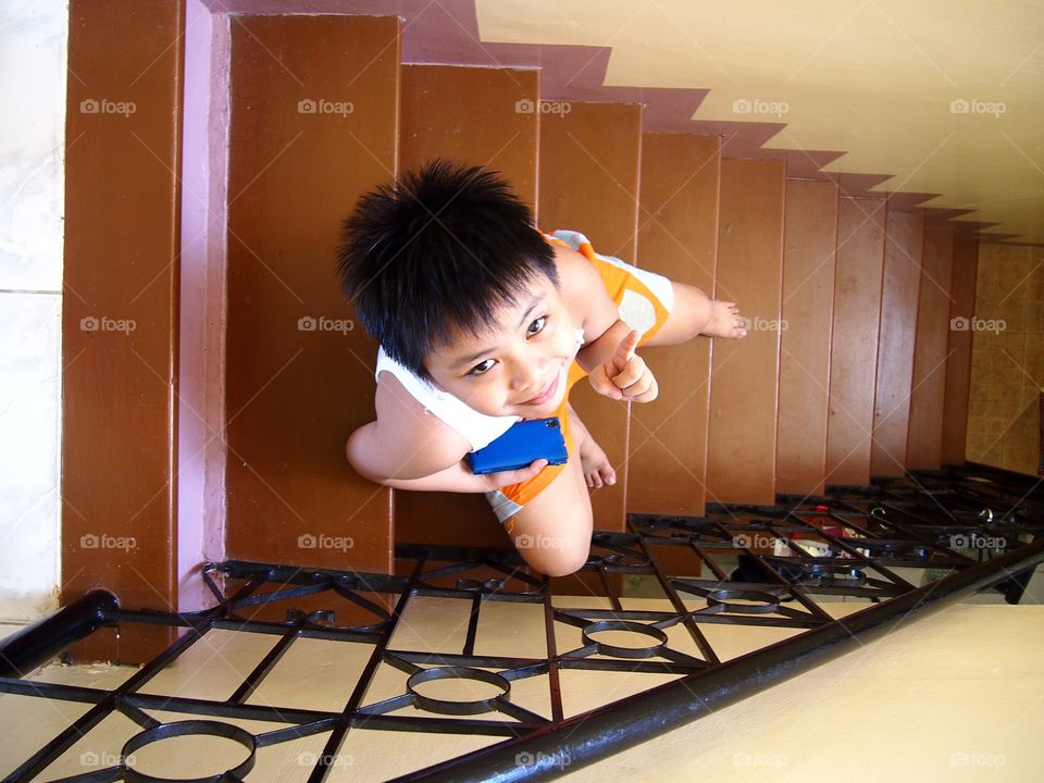 young kid sitting on a set of staircase