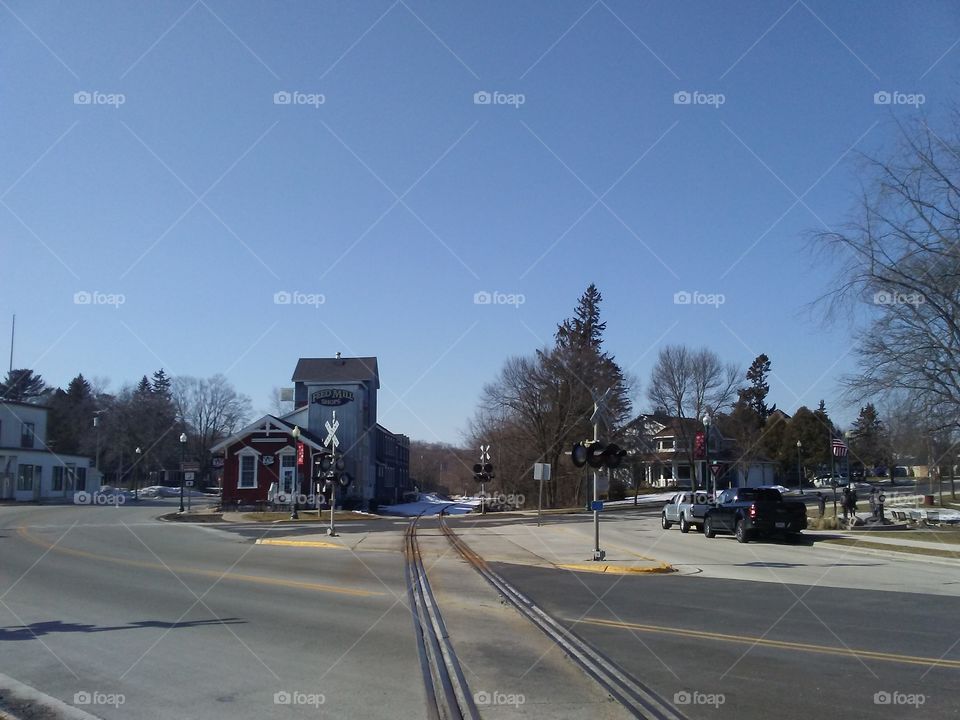 The railroad tracks running along the old feed mill in the center of Elkhart Lake, Wisconsin on a very warm March Sunday afternoon.