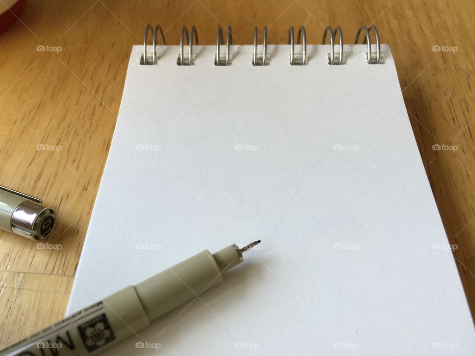 Sketchbook open + pen