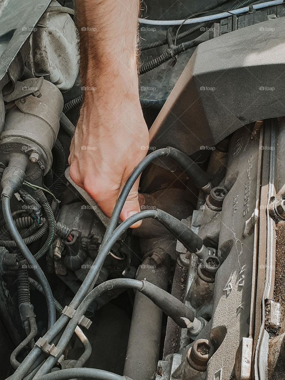 The mechanic checks the oil in the car under the hood, close-up photo