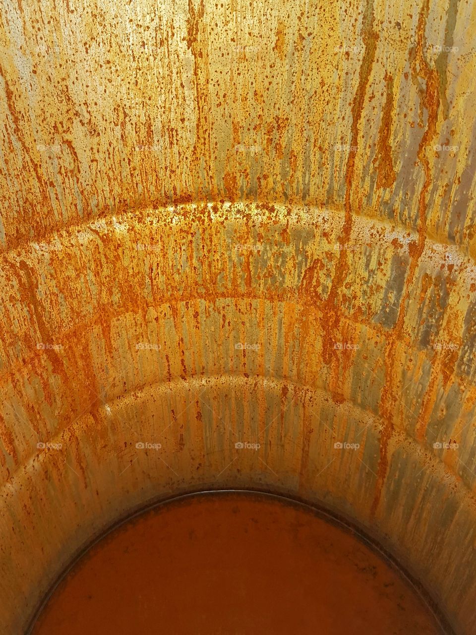 Empty, rusty oil drum.