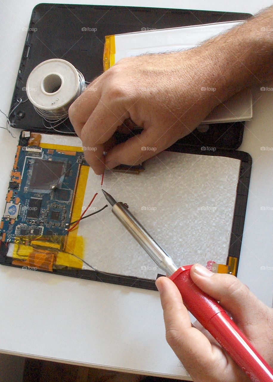 working hands - fixing a tablet PC