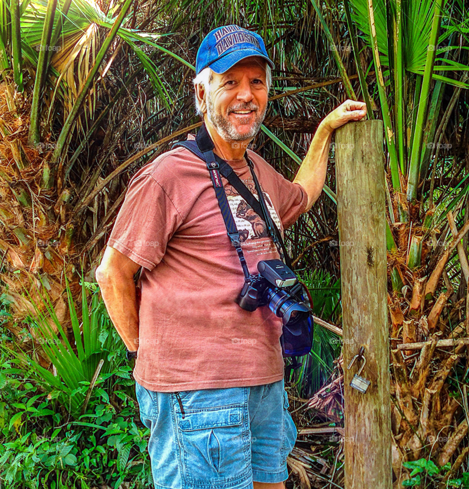 Dad in the park hiking and taking pictures.