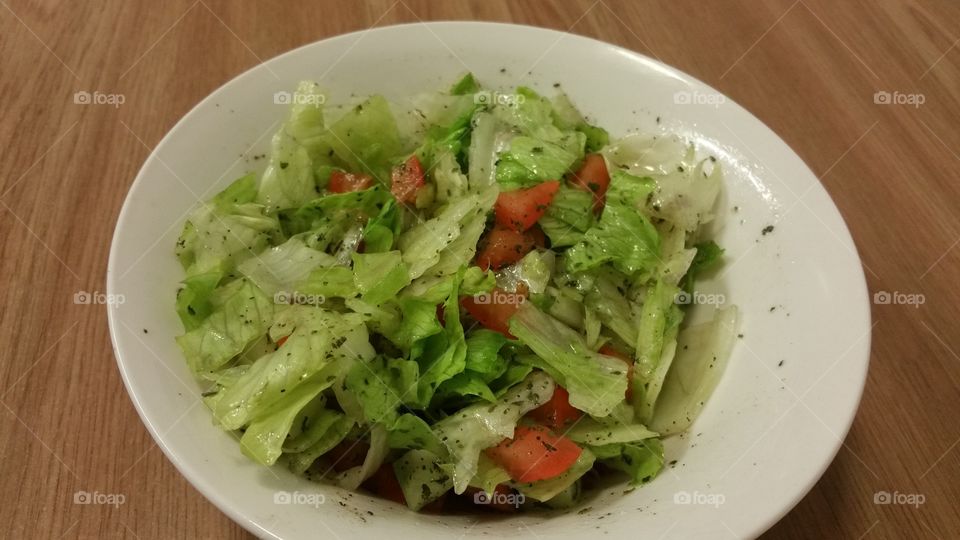 fresh green lettus salad. low calorie healthy salad meal with lettus, cuccumber, tomatto, vegetable, herb and olive oil