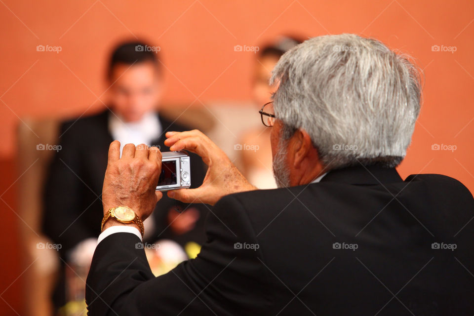 Smile! Man taking a snapshot at a party