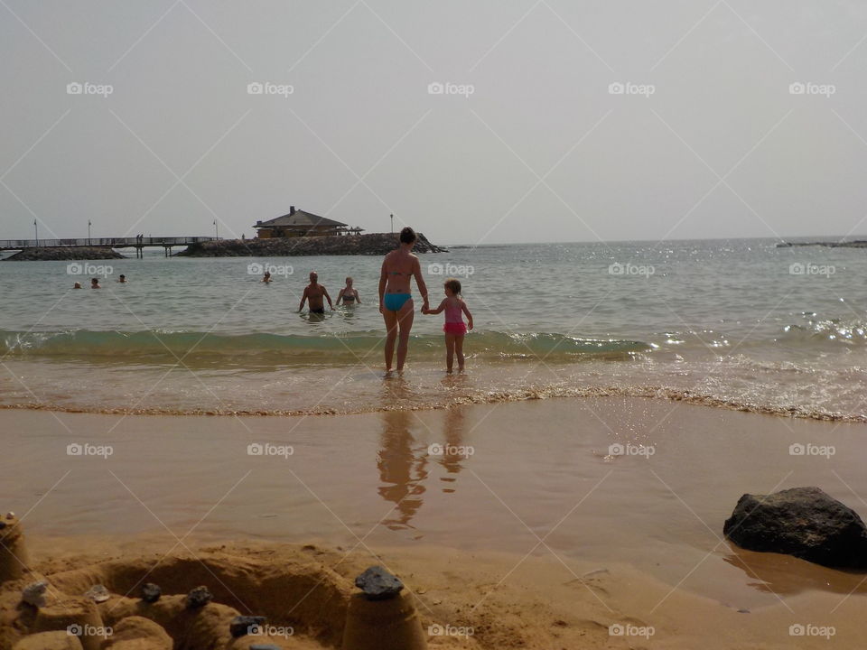 Sandcastle and beach goers 