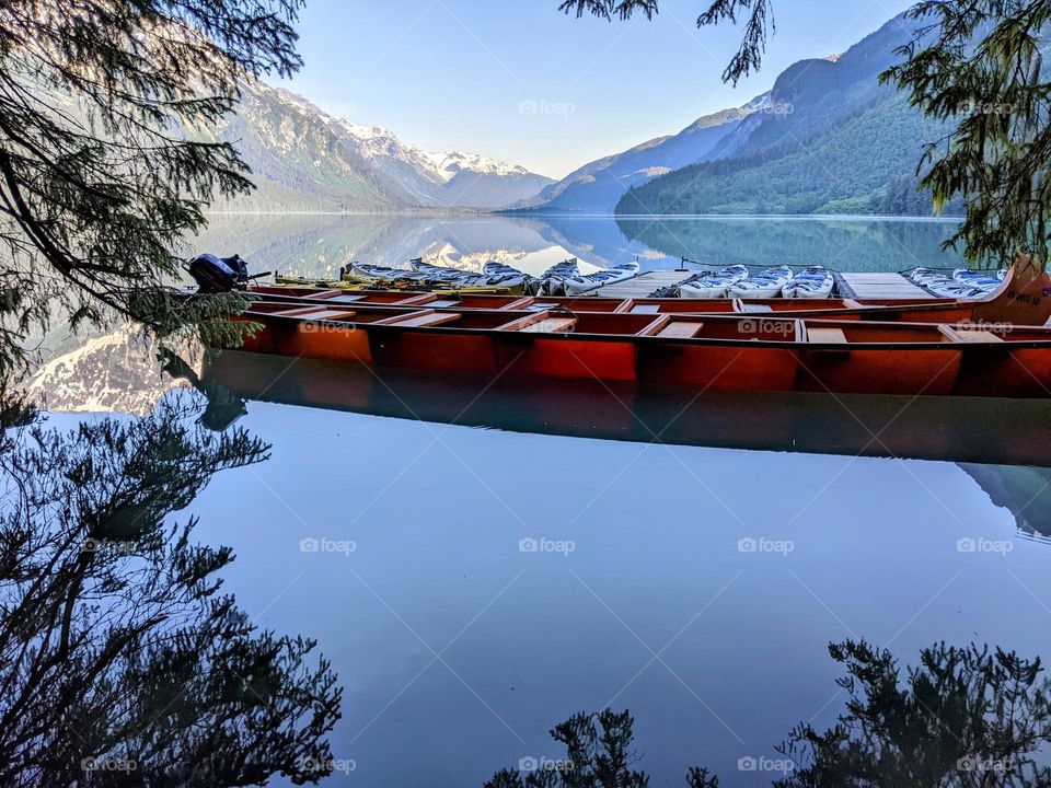 kanoes laying in a mountain lake