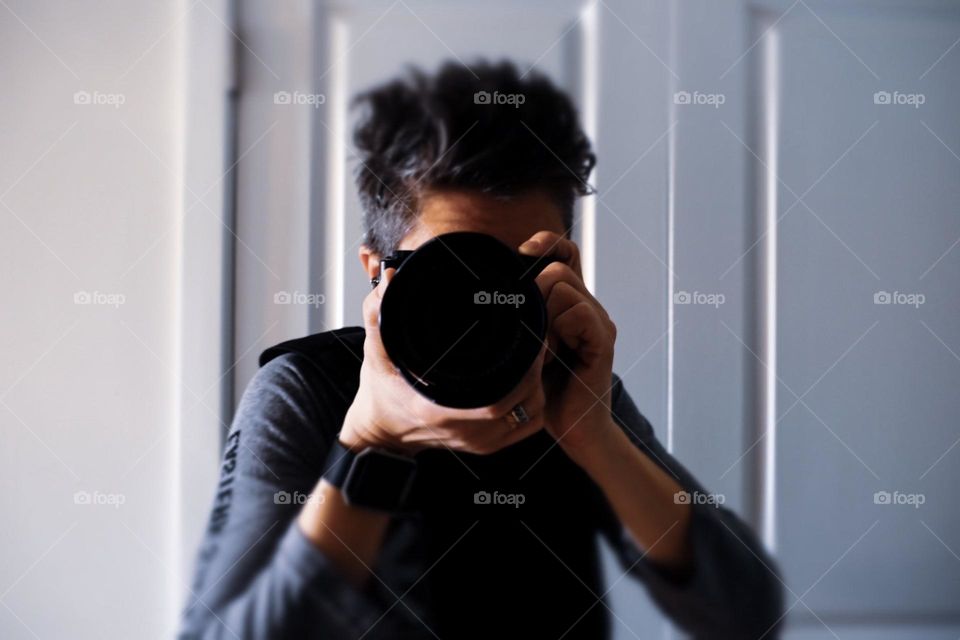 Photographer focuses on subject, looking into the lens, photography in action, focused on photography, you are the subject, subjects perspective