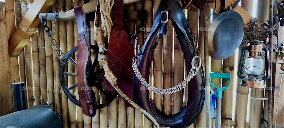 „Ron‘s Whiskey Lounge“ in the rural countryside of „Bavaria“, Germany is decorated decisively „Country Western“ style with leather holsters and saddles on its wooden walls and a miniature statue of a horse. „Yeeehaw !!!“ 2024. Hypnotic Productions