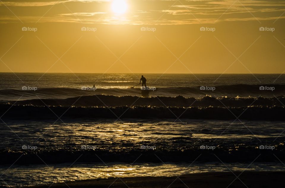 After rising early to take some beach sunrise photos, I noticed a lone surfer silhouetted against the morning sky.