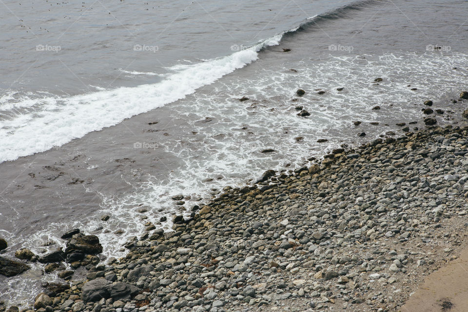 Ocean hitting rocks on shore of the pacific 