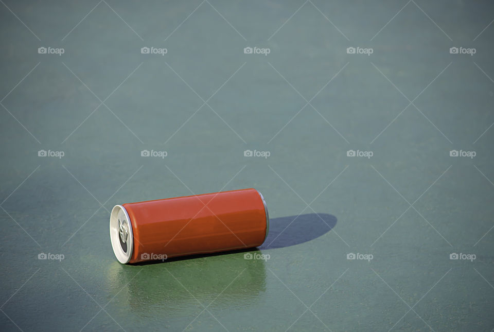 Canned drink red on Concrete floors painted green.