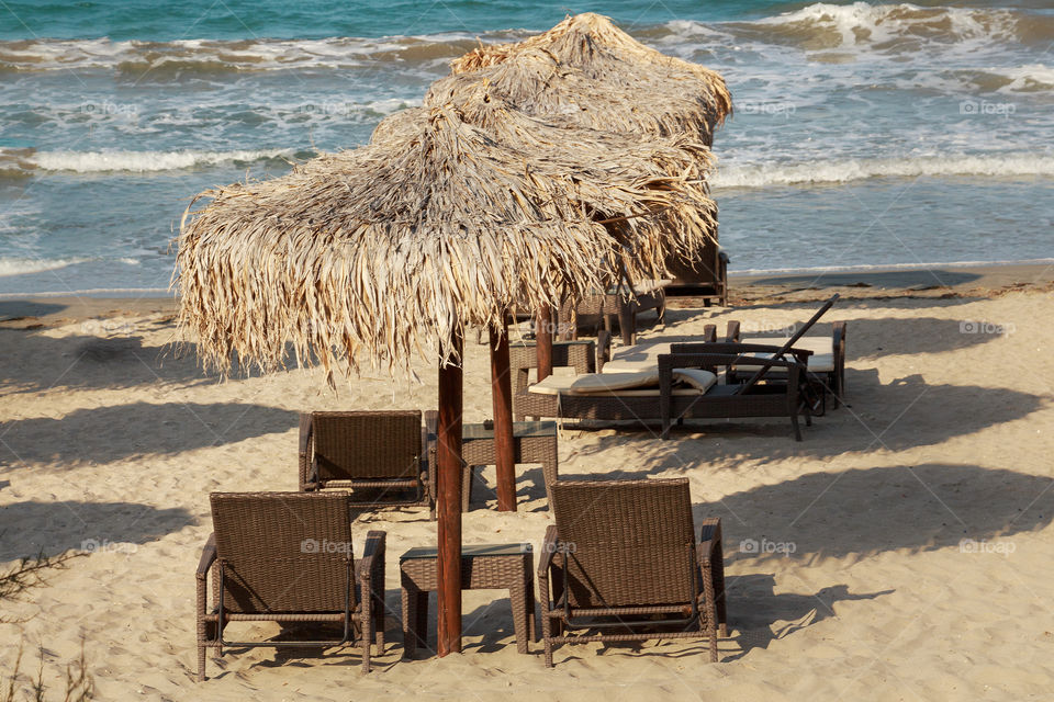 Beach umbrellas and sunbeds at beach in Bulgarian resort Pomorie