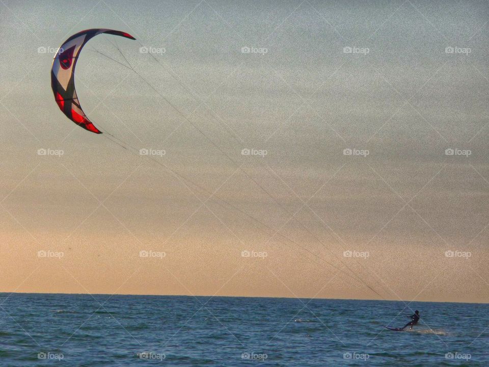 Kiter in the evening sun. Kite surfer in the North Sea