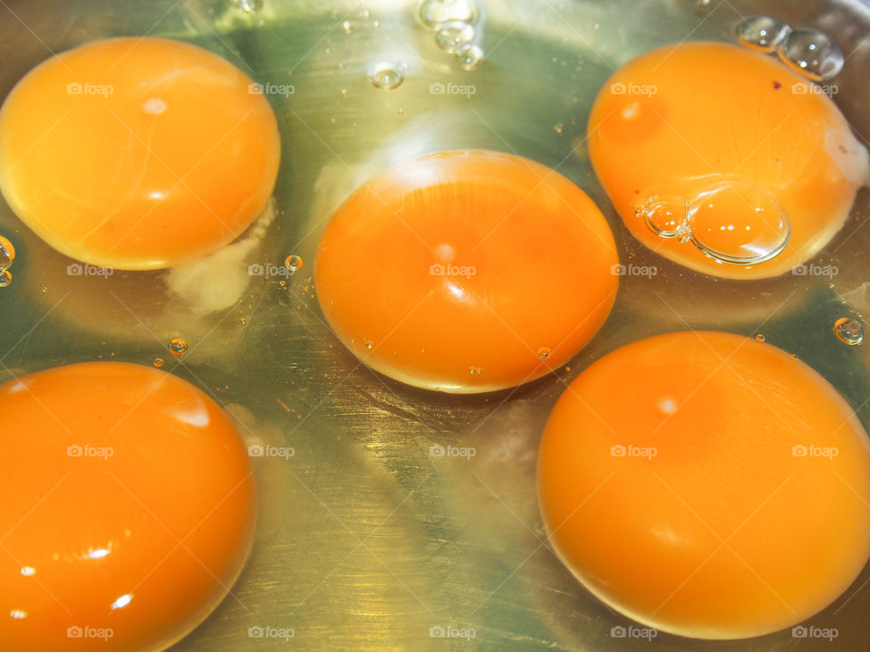 High angle view of egg yolk in frying pan