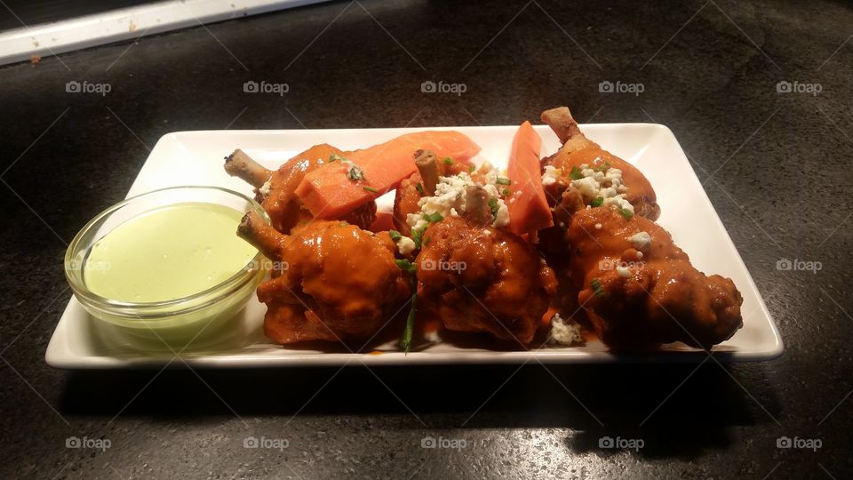 lollipop wings with blue cheese dressing and crumbles with a side of avocado ranch dressing@ Del Frisco's grille, chestnut hill, ma