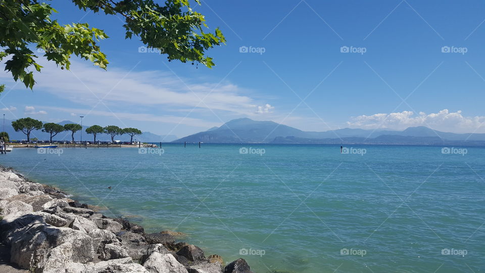 Beautifull Sea with mountains , rocks and tries