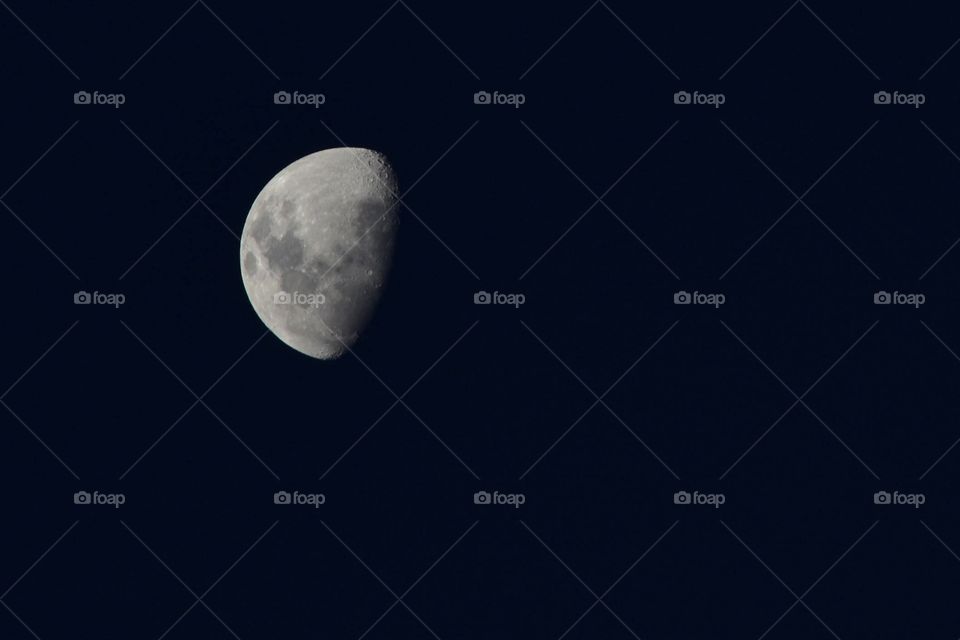 Crescent white moon in dark sky at night space background