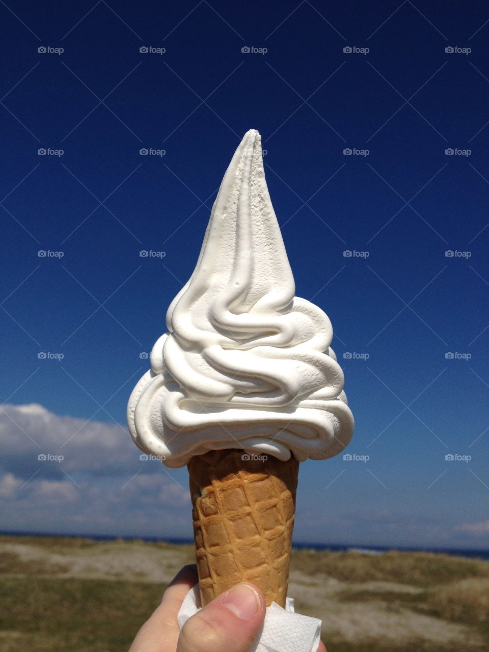 Close-up of hand holding ice cream cone