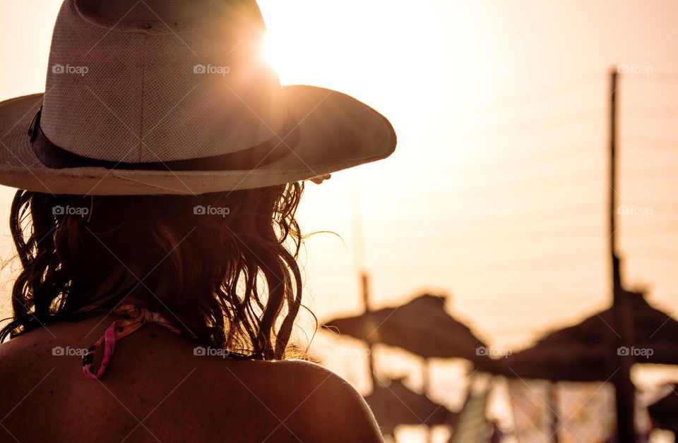 Rear view of woman with hat