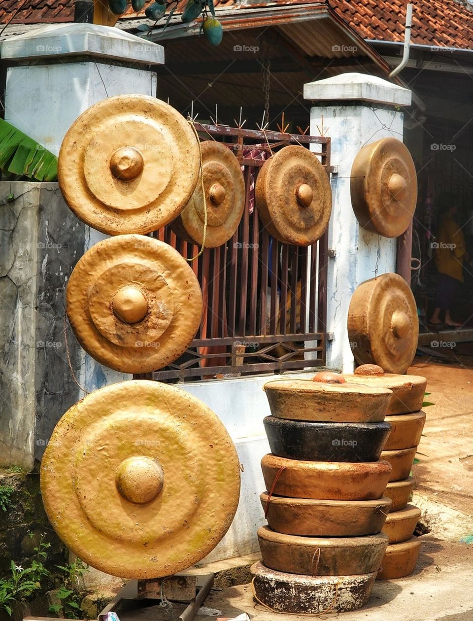 a gong is a percussion instrument originating in east asia and shouteast asia - metal