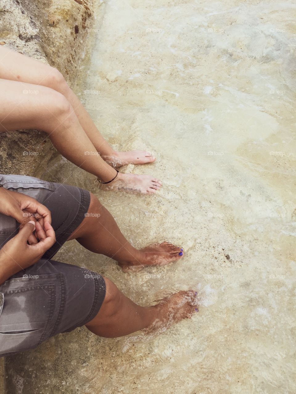 Women Relaxing In The Waters Of The Caribbean Ocean In St. Maarten, Feet In The Water, Beach Scene 