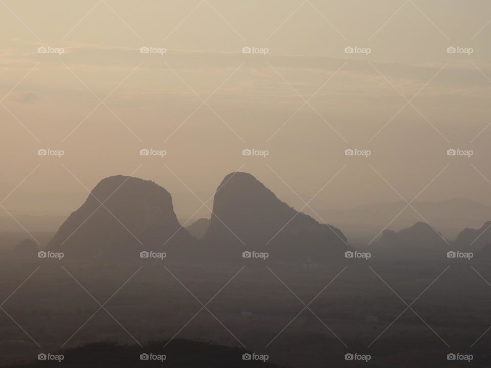 Early morning view at the mountains in fog and with the shape of triangle