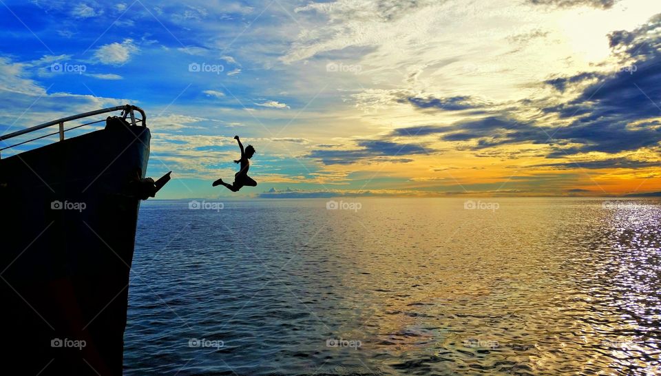 Jumping off the boat into the ocean to feel the coolness during the summer season.