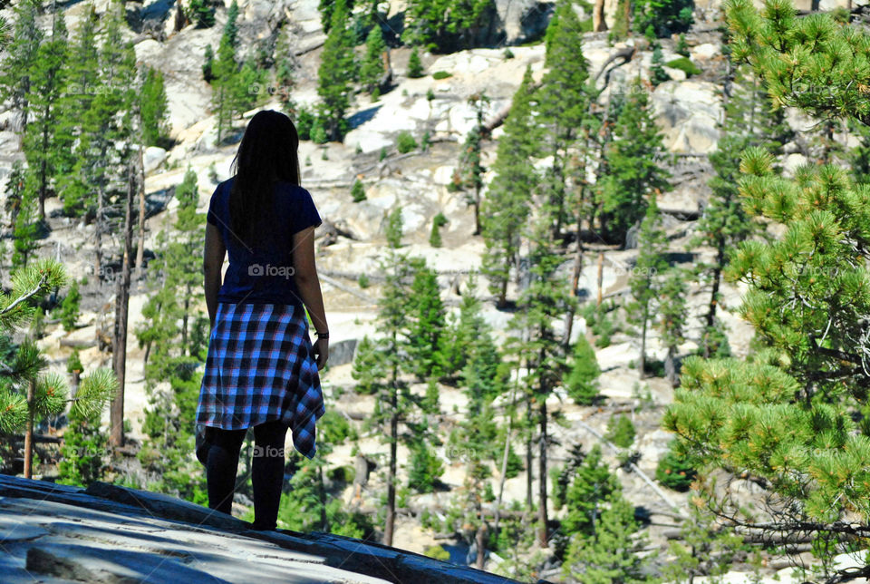 Girl hiker on top of mountain, cliff