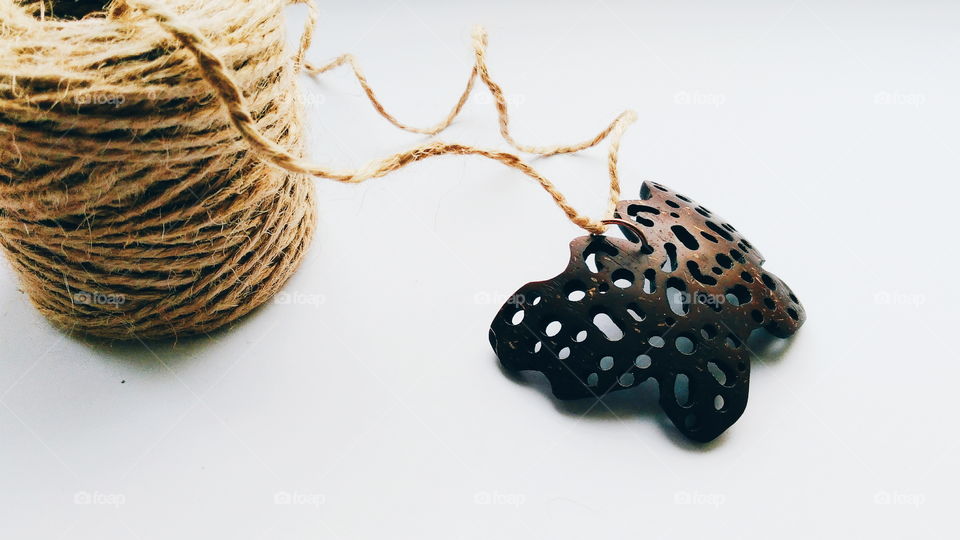 pendant butterfly from coconut on a white background