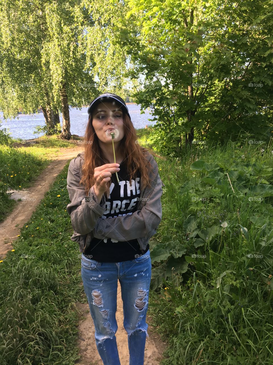 girl blowing dandelion